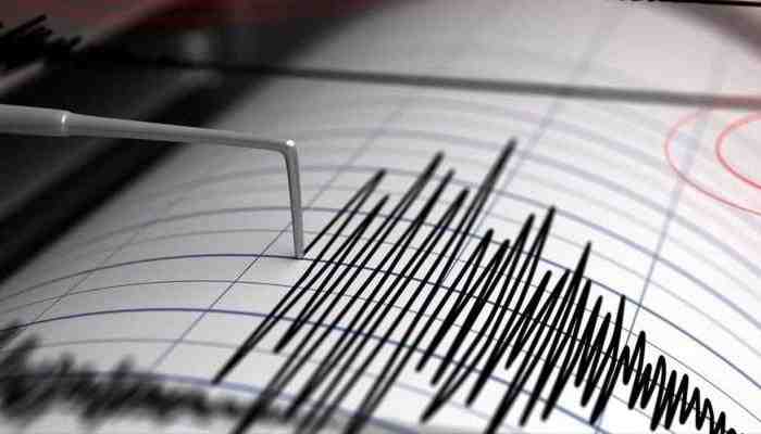 A seismograph pen drawing zigzag lines to measure an earthquake
