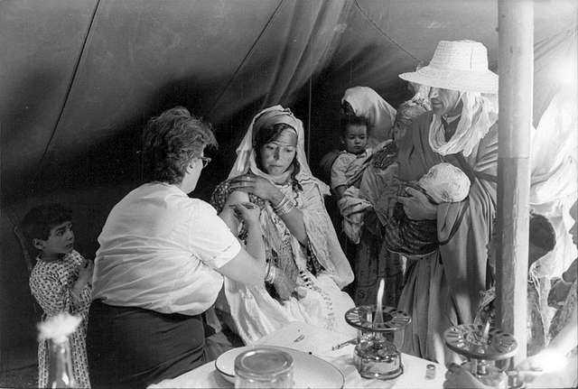 A women getting treatment by a nurse during the Algerian War