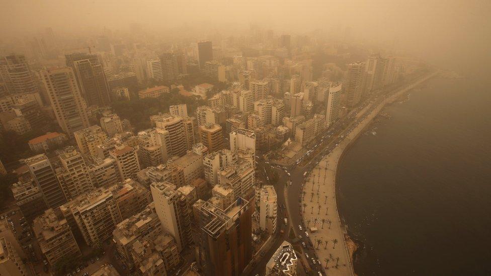 Dust and sand storms affect visibility over a city Dust and sand storms affect visibility over a city