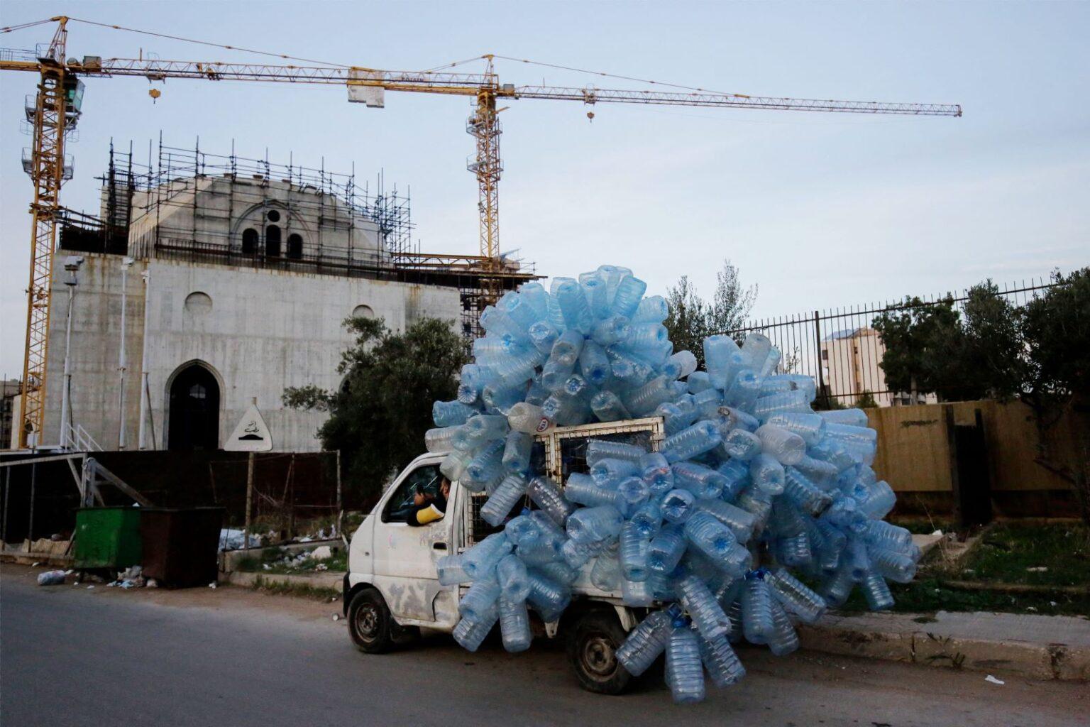 A van driver transports empty plastic containers for recycling in the northern Lebanese port city of Tripoli on December 10, 2024. (Photo by Ibrahim Chalhoub / AFP) A van driver transports empty plastic containers for recycling in the northern Lebanese port city of Tripoli on December 10, 2024. (Photo by Ibrahim Chalhoub / AFP)