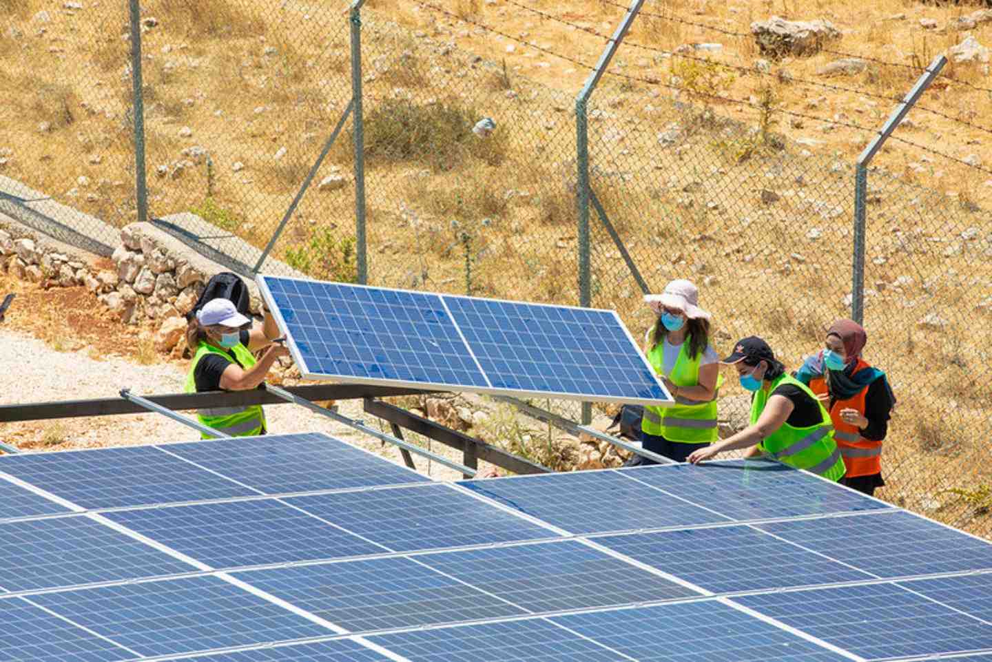 Workers installing solar pannels.