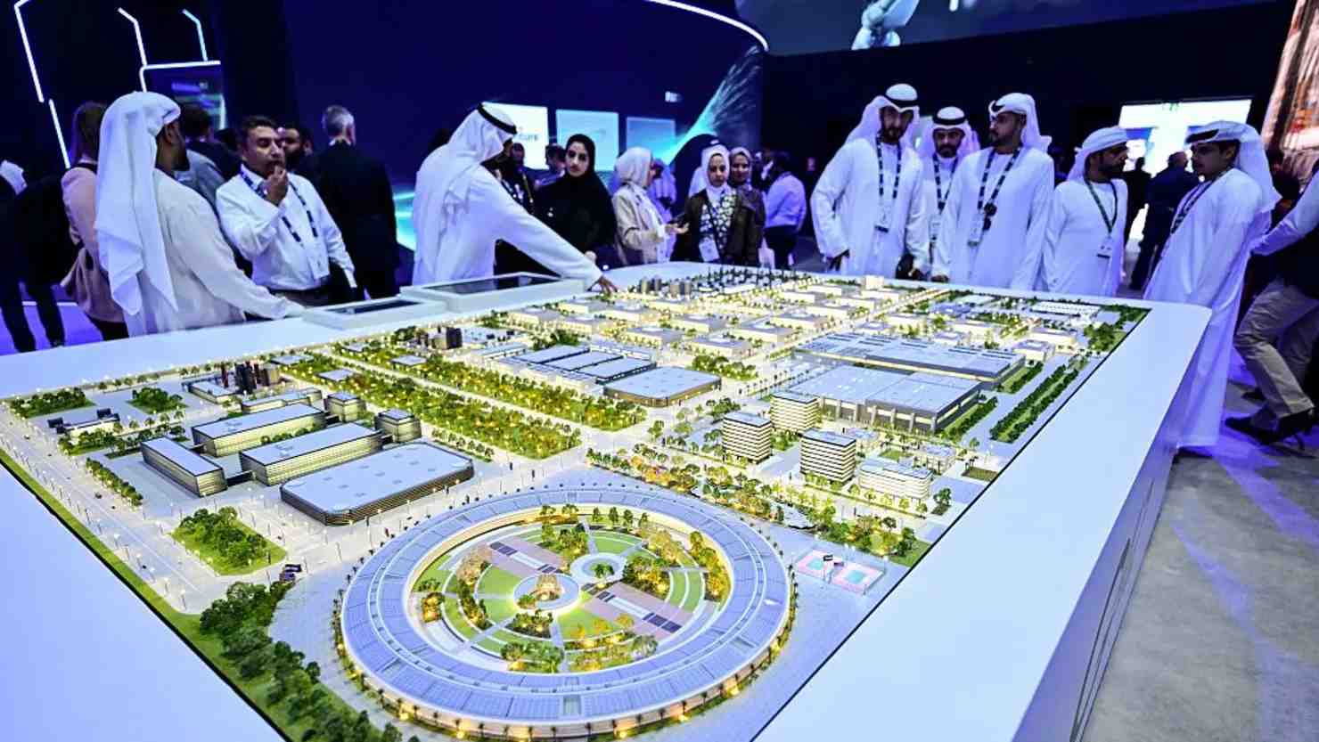 Guests look at a model of the largest data center in the UAE under construction in Abu Dhabi. (Image Credit: AFP)