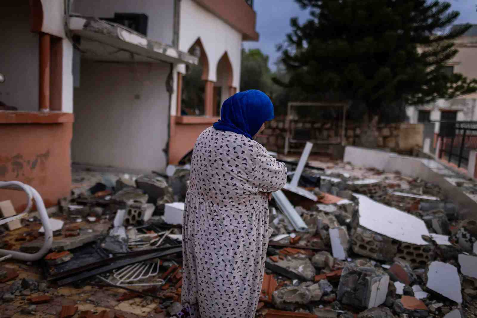 Dhayra, Lebanon. November 27, 2023, Norma Abu Sari walks through her destroyed house in the Lebanese border village. Photo: UNICEF/UNI561664